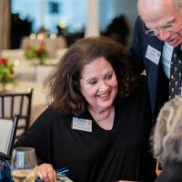 Dottie Johnson talking with two guests.